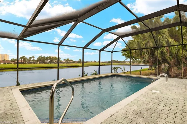 Outdoor pool featuring a water view, a patio area, and a lanai