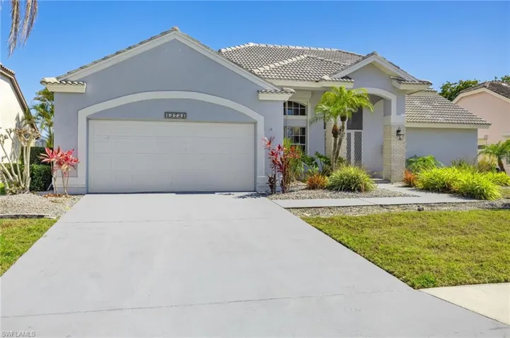Mediterranean / spanish home featuring a tile roof, an attached garage, concrete driveway, and stucco siding
