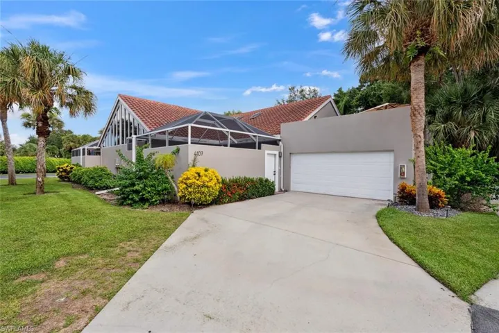 Mediterranean / spanish-style home featuring a front lawn and a garage