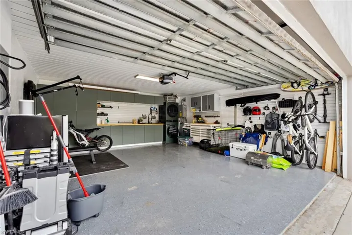 Garage featuring a workshop area and a garage door opener