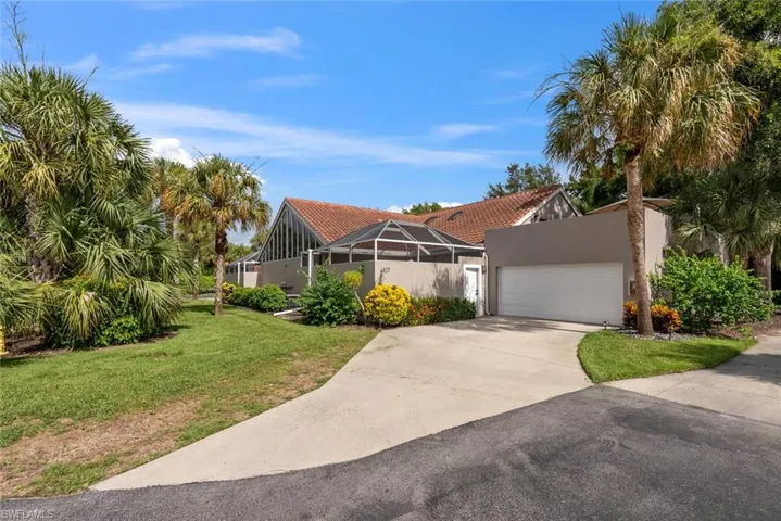 View of front of house featuring a garage and a front lawn
