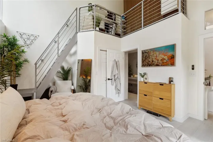 Bedroom with a high ceiling and loft space