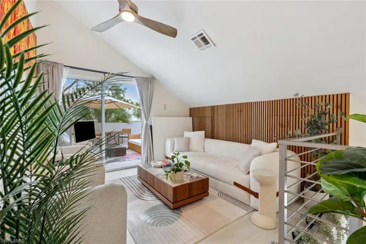 Loft with vaulted ceiling and ceiling fan