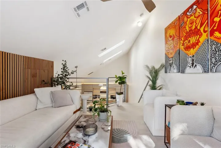 Loft with ceiling fan and vaulted ceiling