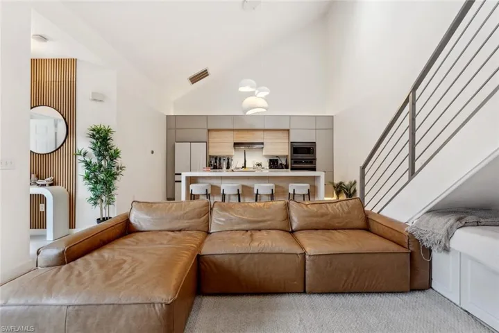 Living room featuring a high vaulted ceiling