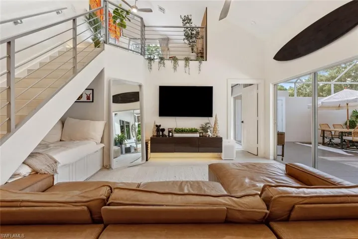 Living room featuring high vaulted ceiling and ceiling fan
