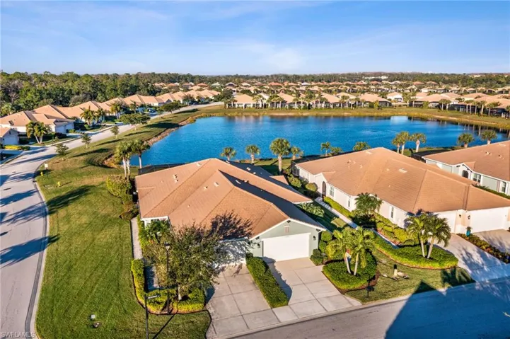 Birds eye view of property with a water view