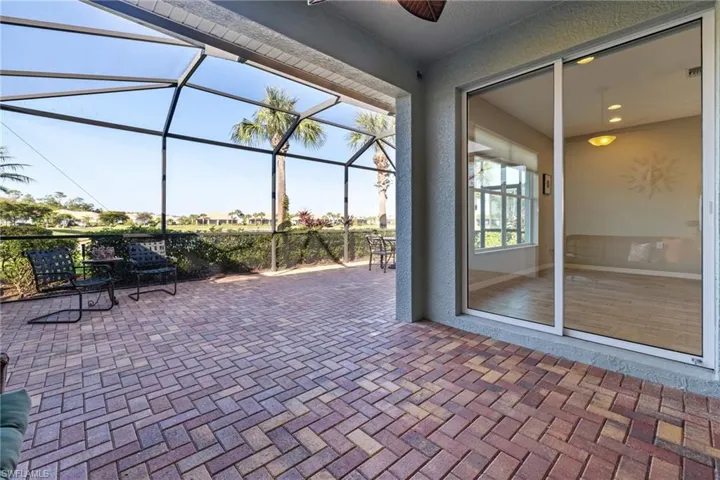 View of patio featuring glass enclosure