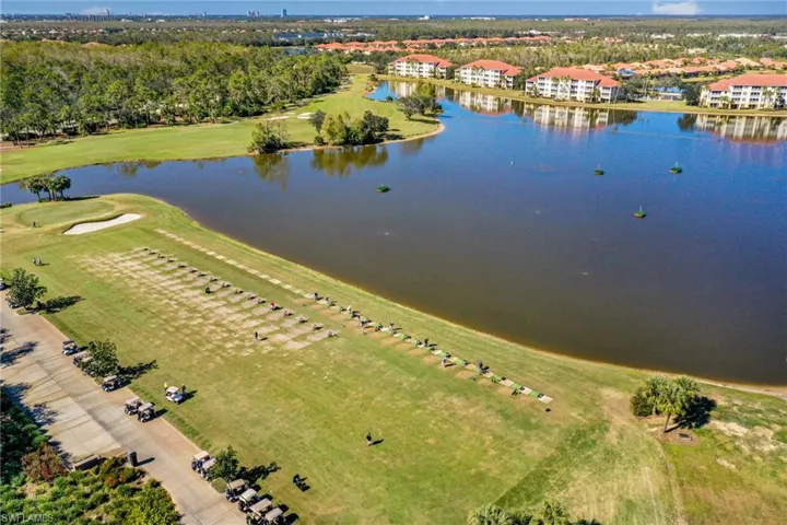 Birds eye view of property with a water view