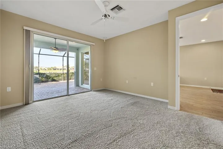 Empty room with carpet flooring and ceiling fan