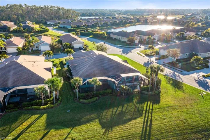 Birds eye view of property with a water view