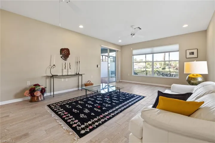 Living room with wood-type flooring and ceiling fan