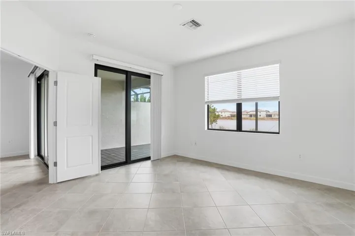 Empty room featuring baseboards and light tile patterned floors