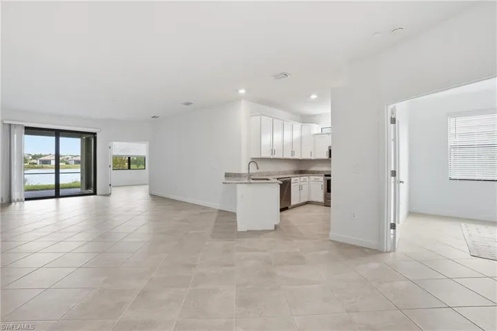 Unfurnished living room featuring plenty of natural light, light tile patterned flooring, and recessed lighting