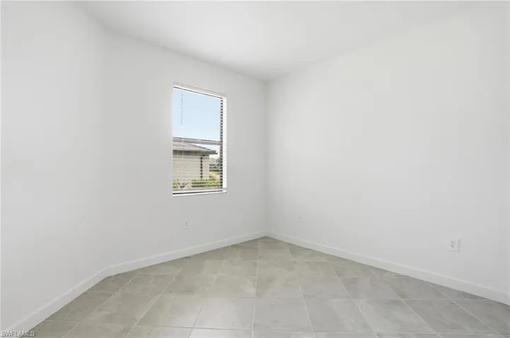 Spare room featuring baseboards