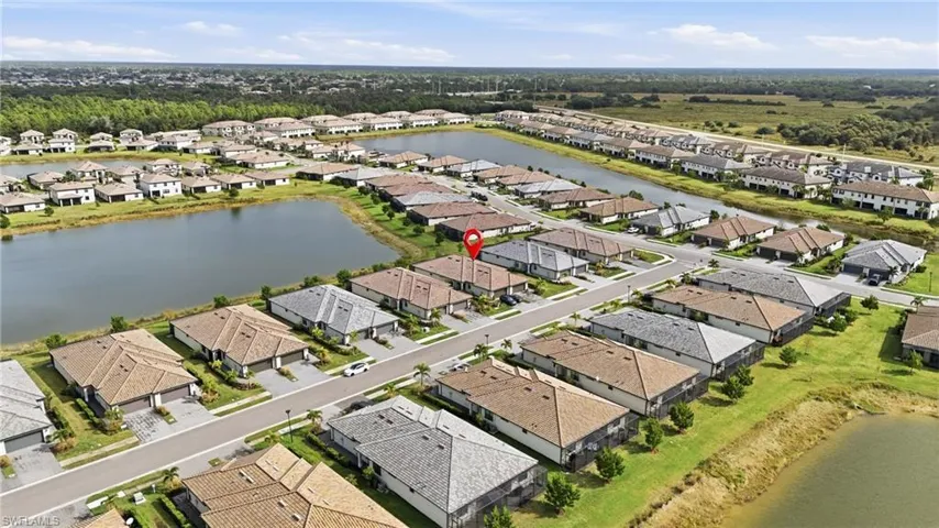 Aerial view of property's location with a large body of water and nearby suburban area