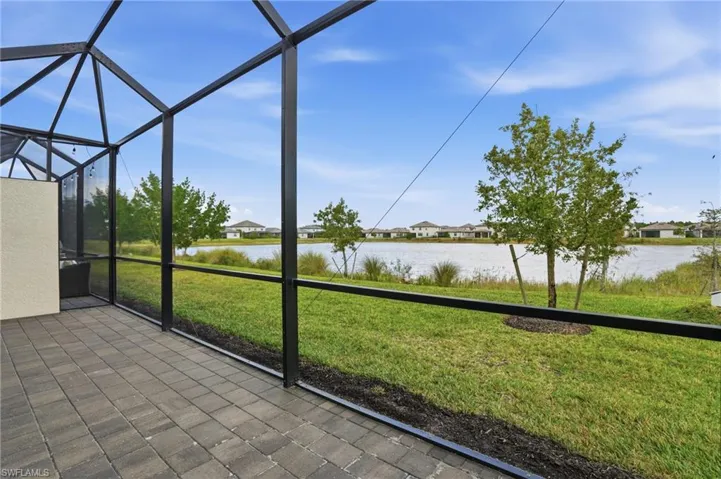 Unfurnished sunroom featuring a water view and a patio