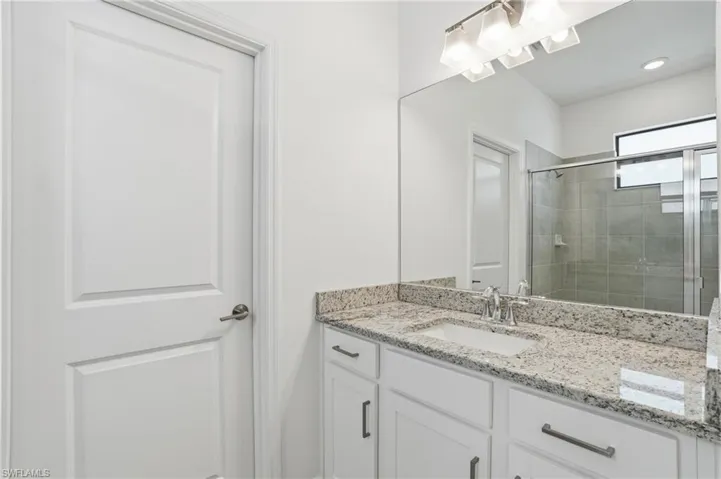 Bathroom with vanity and a stall shower