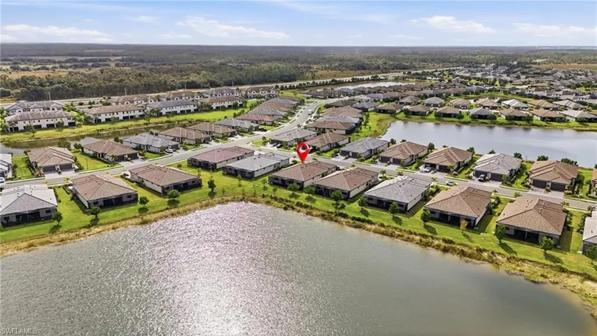 Aerial view of residential area featuring a nearby body of water