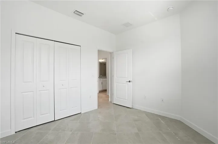 Unfurnished bedroom featuring baseboards and a closet