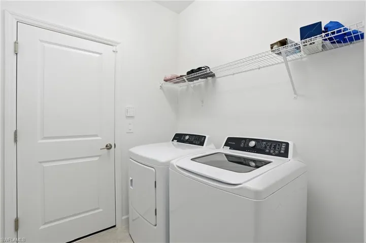 Washroom with washer and clothes dryer