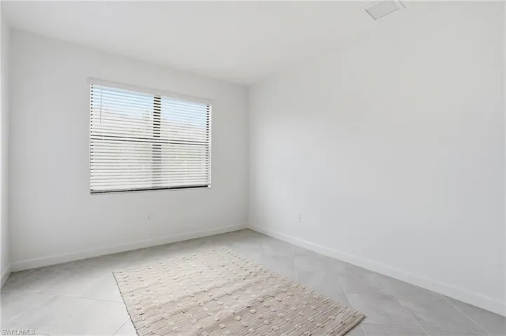 Empty room featuring baseboards