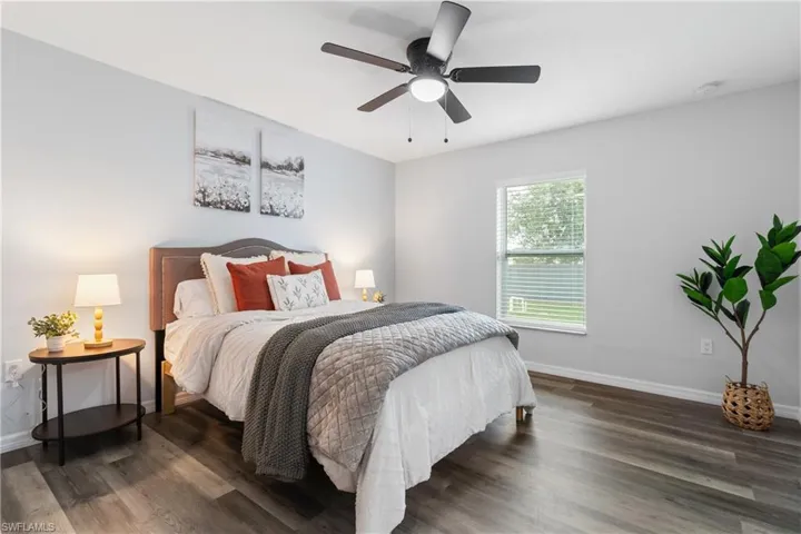 Bedroom with baseboards, a ceiling fan, and wood finished floors