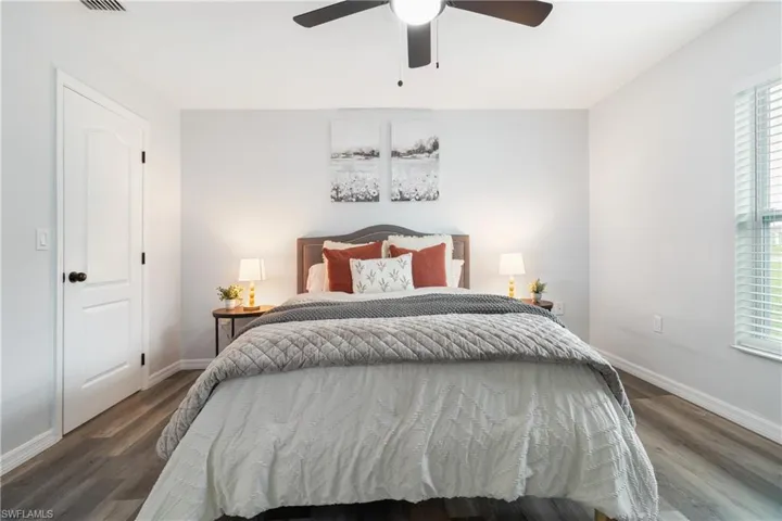 Bedroom with ceiling fan, baseboards, and wood finished floors