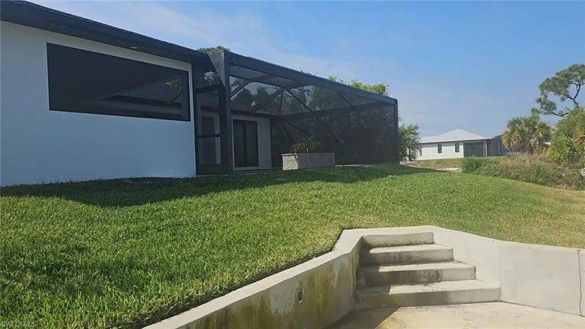 View of yard featuring a lanai