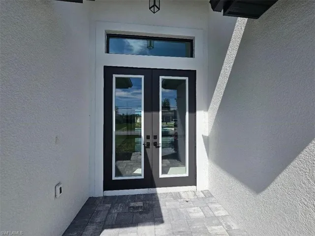 Entrance to property with french doors and stucco siding