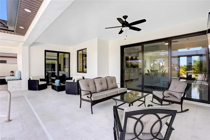 View of patio with ceiling fan and outdoor lounge area