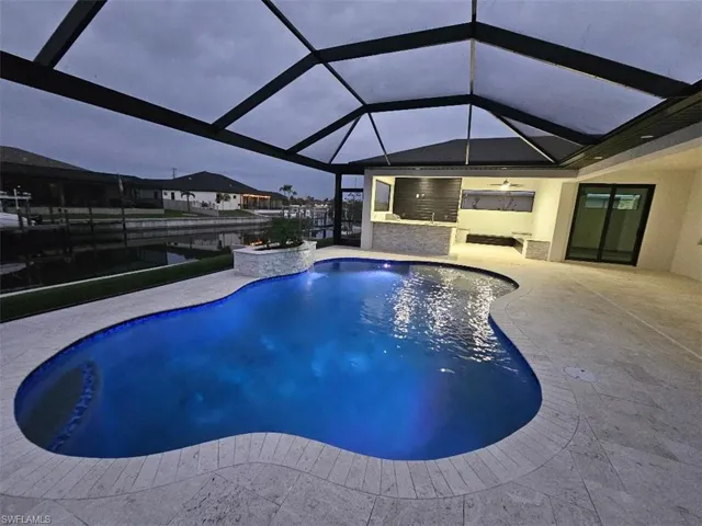 Pool with glass enclosure and a patio area