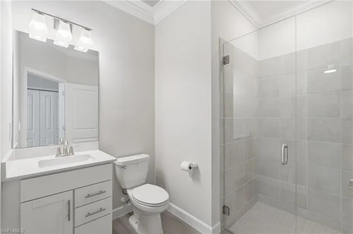 White vanity with an integrated rectangular sink, chrome faucet, and quartz countertop