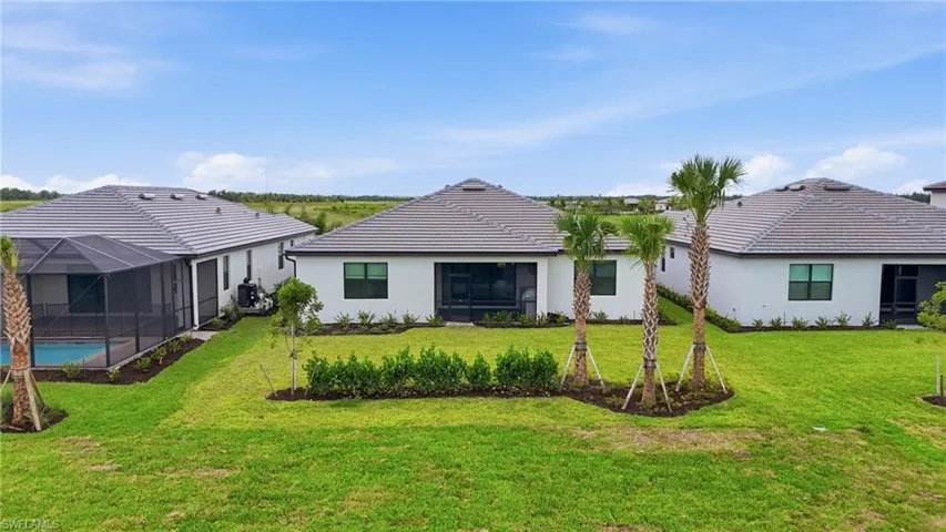 Spacious backyard with a screened enclosure and swimming pool