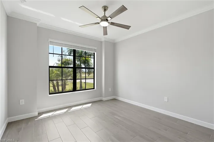 Recessed lighting with a ceiling fan, crown molding, white painted walls, large window with blinds, and wood-finish flooring