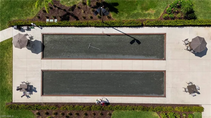 Dual rectangular bocce courts framed by concrete pathways