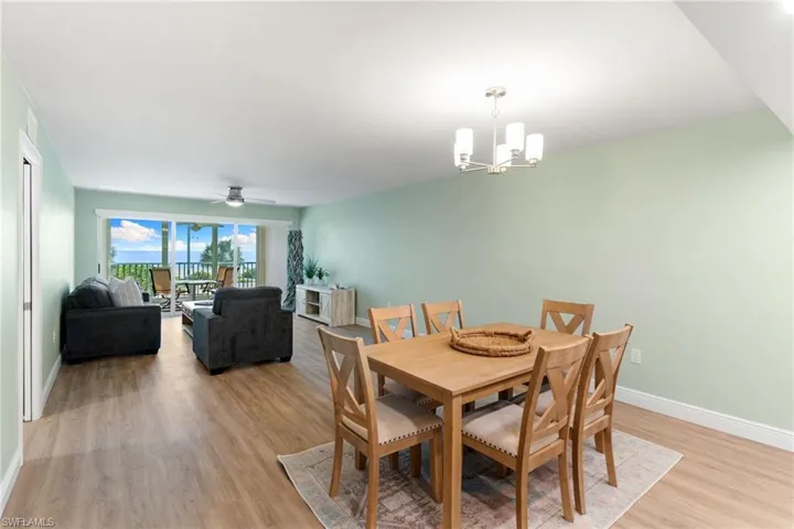 Dining room featuring light wood-style floors, a chandelier, and ceiling fan