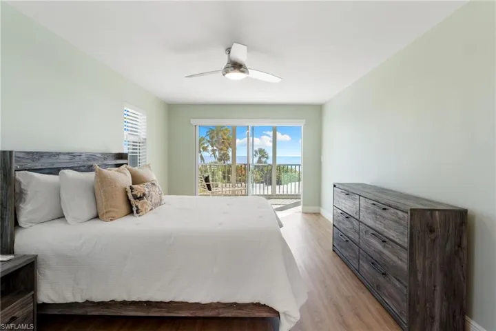 Primary Bedroom featuring light wood-style flooring, access to outside, and ceiling fan