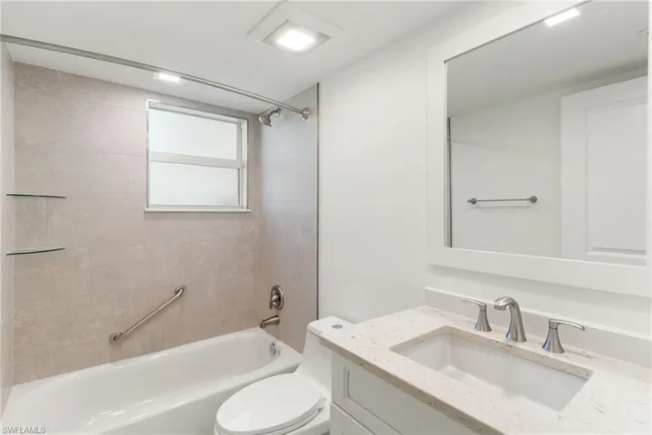 Bathroom with vanity and shower / tub combination