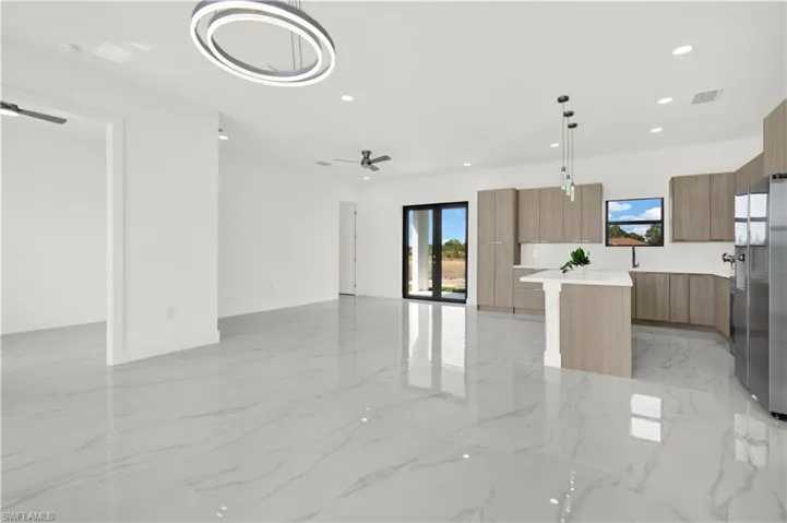 Unfurnished living room featuring recessed lighting and a ceiling fan