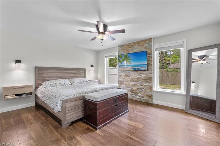 Bedroom featuring dark wood-style floors and a ceiling fan