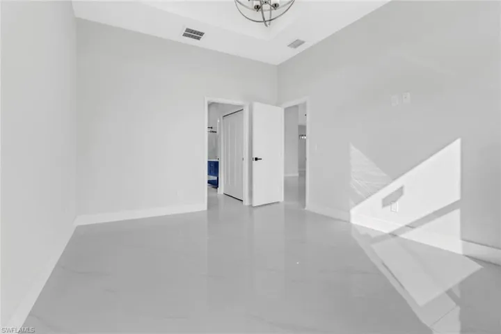 Unfurnished room with a tray ceiling