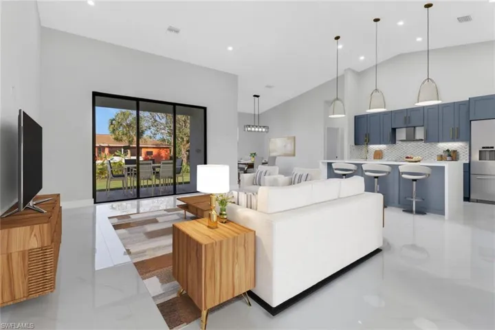 Living room featuring high vaulted ceiling