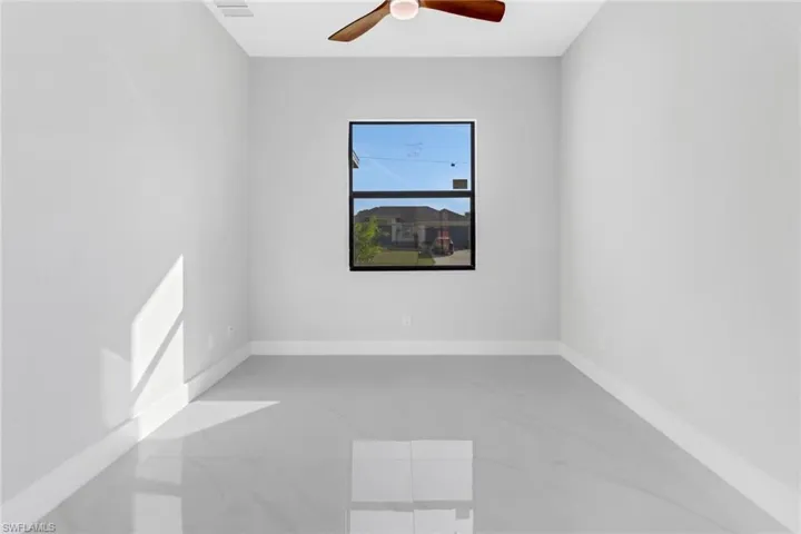 Unfurnished room featuring ceiling fan