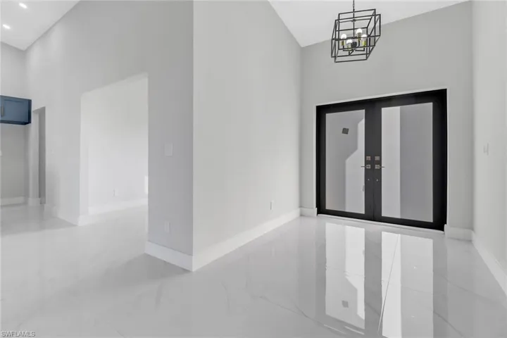 Foyer featuring a notable chandelier and french doors