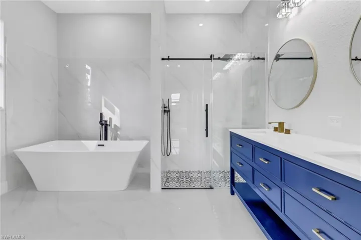 Bathroom featuring plus walk in shower and vanity