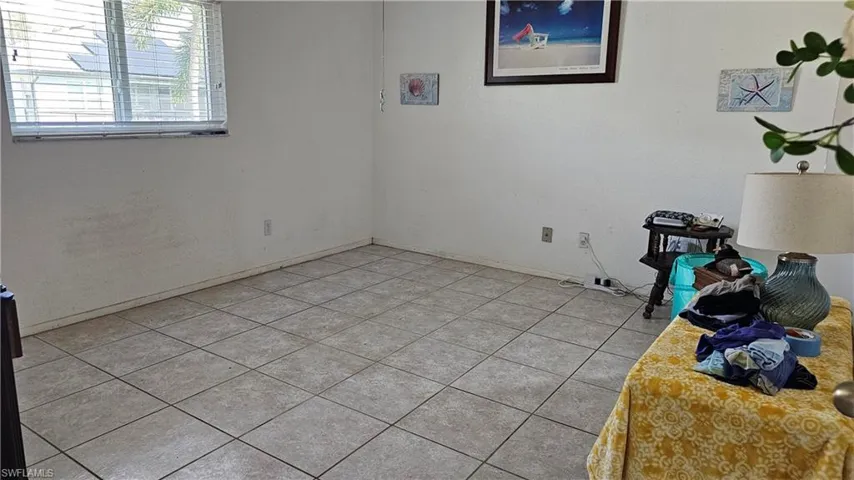 Unfurnished room with light tile patterned flooring