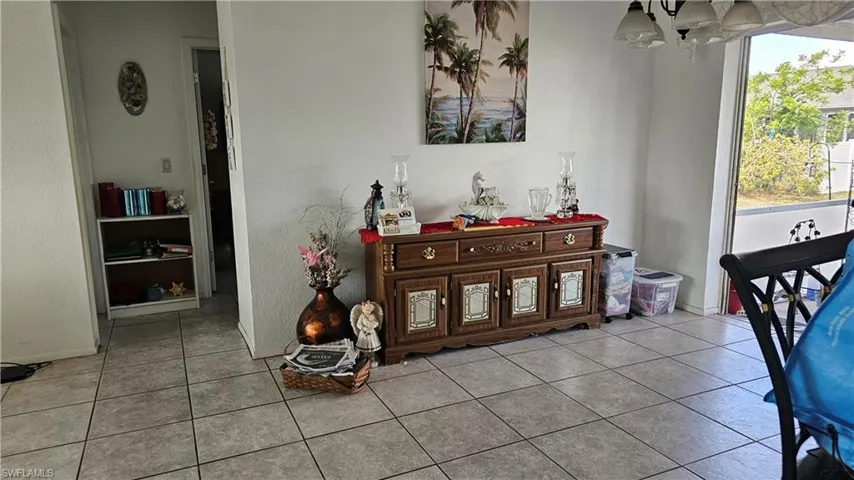 Dining room featuring light tile patterned flooring and hanging lights