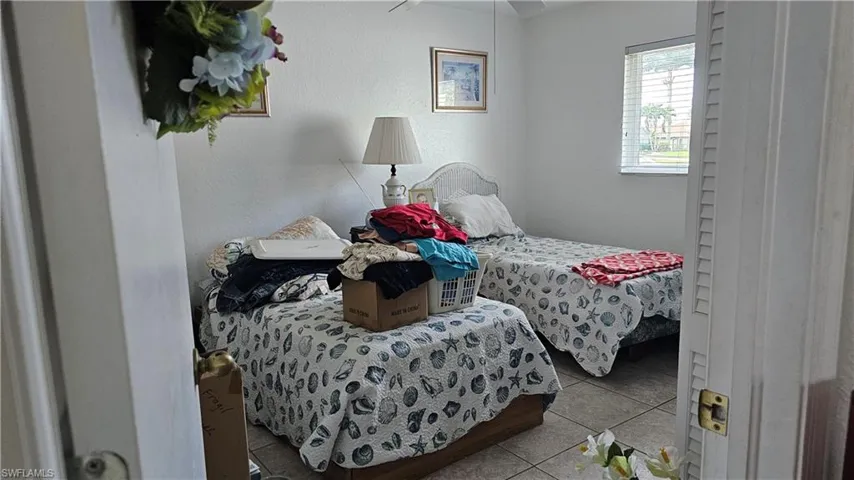 Bedroom featuring light tile patterned flooring and a ceiling fan