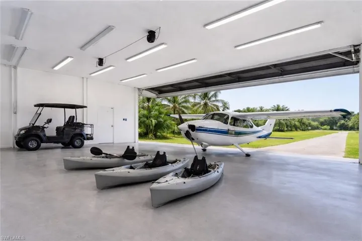 The 29'5" x 36'7" hangar-style garage offers substantial space for vehicles, gear, and island toys and may appeal to owners of certain light aircraft, but exact aircraft fit depends on the clear door opening, interior height, tail height, and wing configuration. By wingspan alone, many common STOL aircraft exceed this width, including the Maule M-7 at about 32'11" and the Cessna 182 at 36'